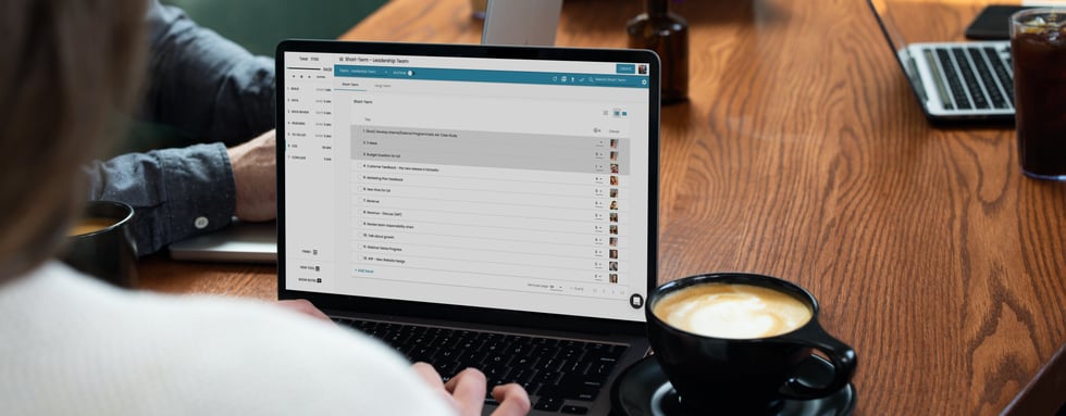 Employees using the Ninety app in a cafe or coworking setting.