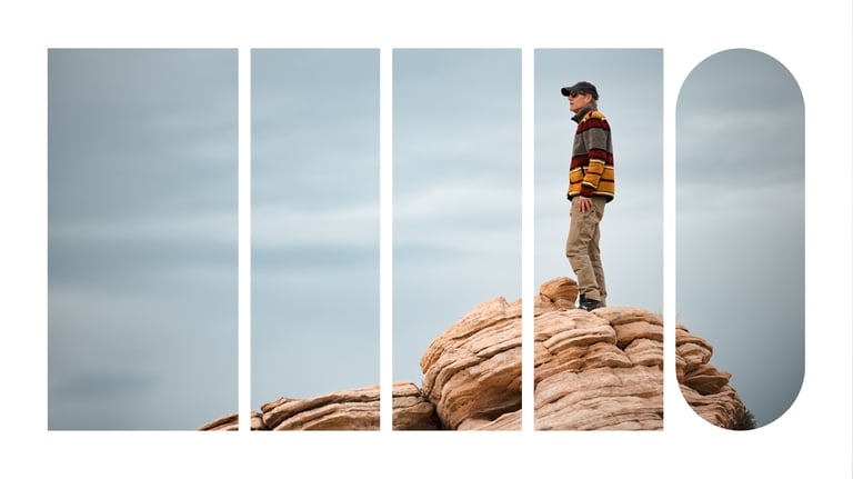 Mark Abbott, CEO of Ninety, standing on top of a rock formation, looking into the distance.