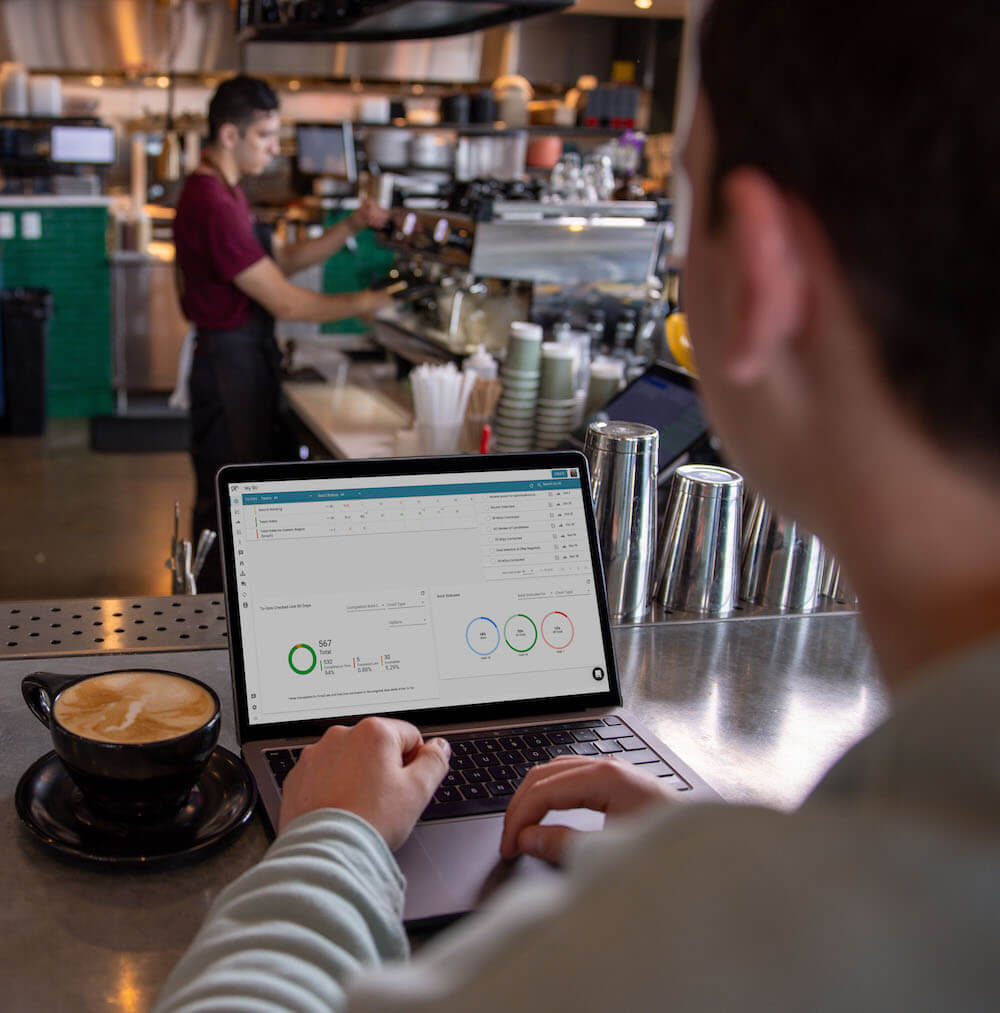 An employee working in the Ninety app at a cafe